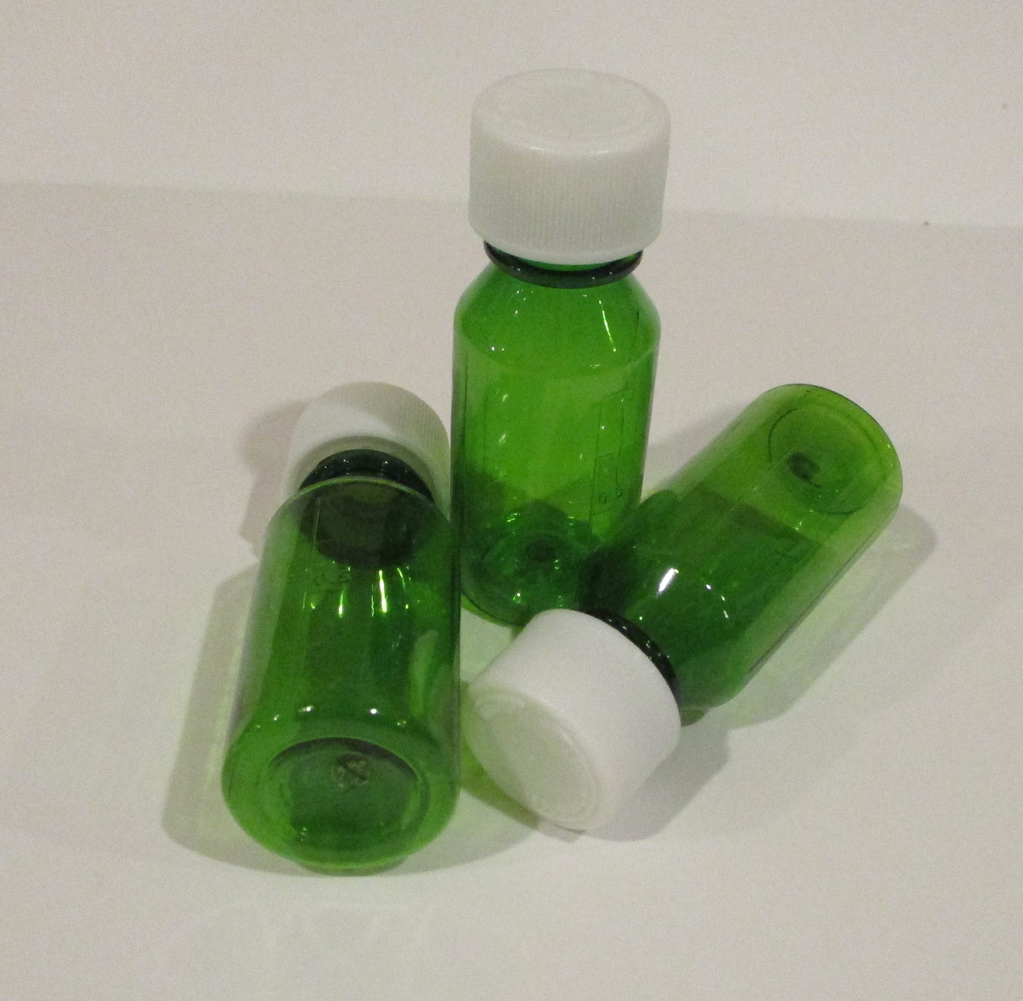 1 Ounce Graduated Oval Plastic Medical Bottles With CR Caps-Amber-Green, or Cobalt Blue